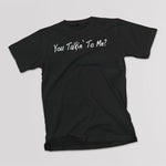 You Talk'in To Me? adult black t-shirt on a table