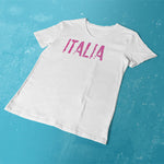 Distressed Italia pink glitter ladies v-neck white t-shirt on a table